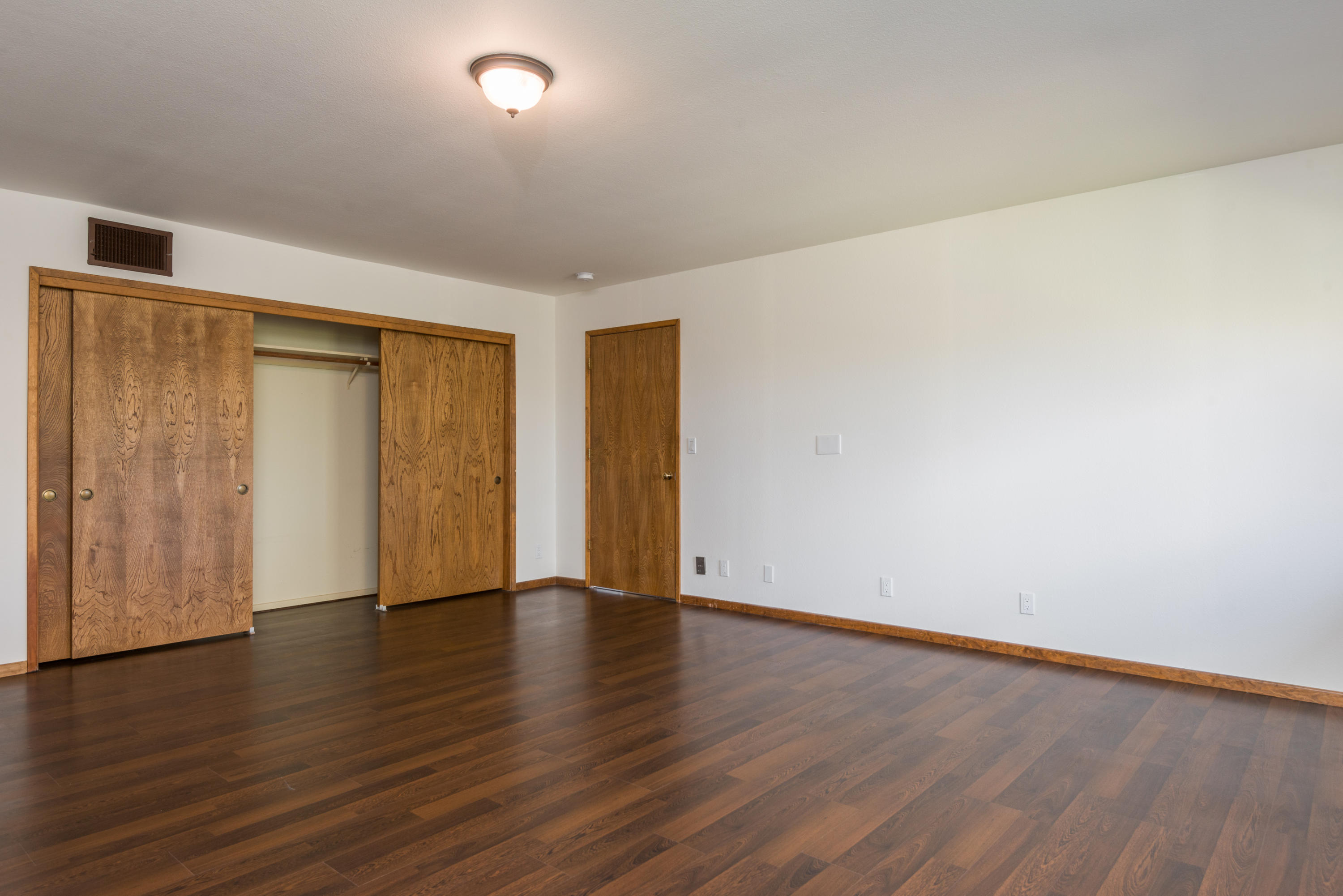 1815 Tularosa Road Lompoc, CA 93436 - Photo 19 of 35 a view of an empty room with wooden floor and a window