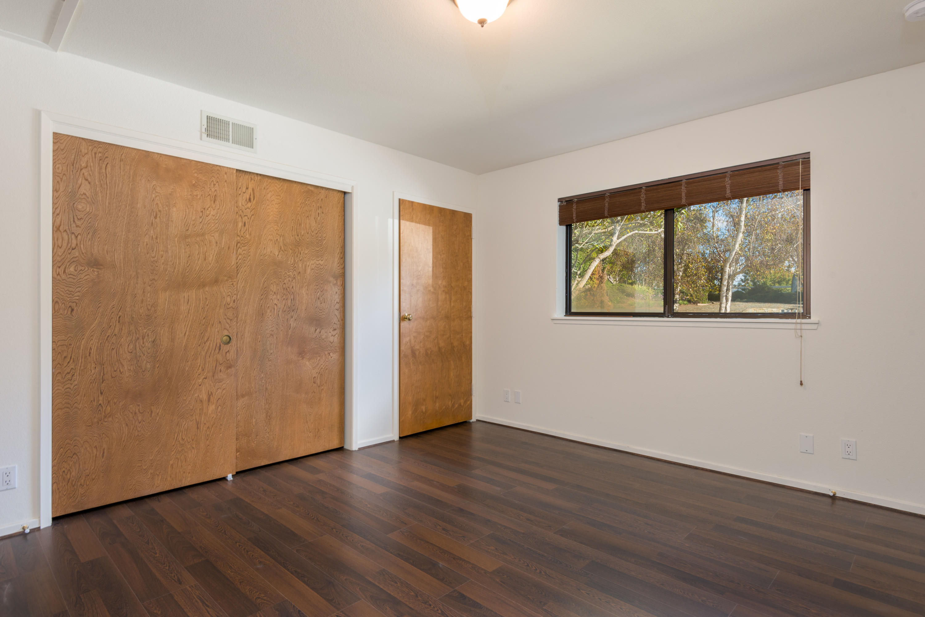 1815 Tularosa Road Lompoc, CA 93436 - Photo 21 of 35 a view of an empty room with wooden floor and a window