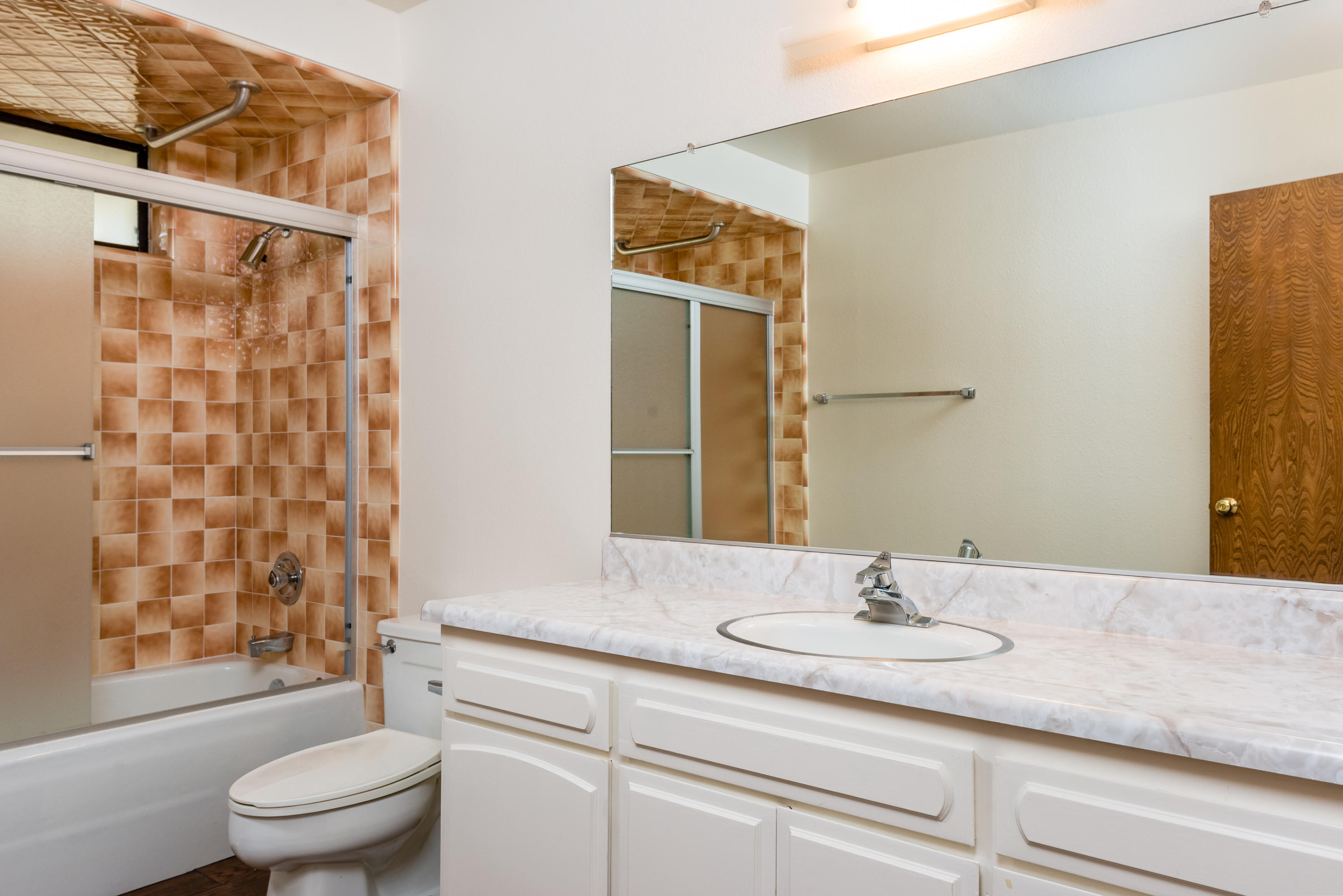 1815 Tularosa Road Lompoc, CA 93436 - Photo 22 of 35 a bathroom with a granite countertop sink a toilet and shower