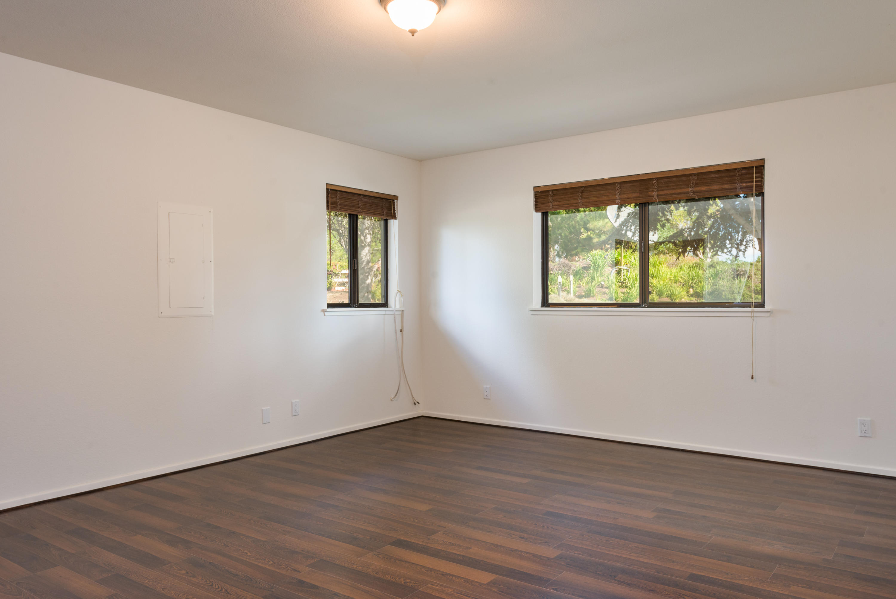 1815 Tularosa Road Lompoc, CA 93436 - Photo 23 of 35 a view of an empty room with wooden floor and a window