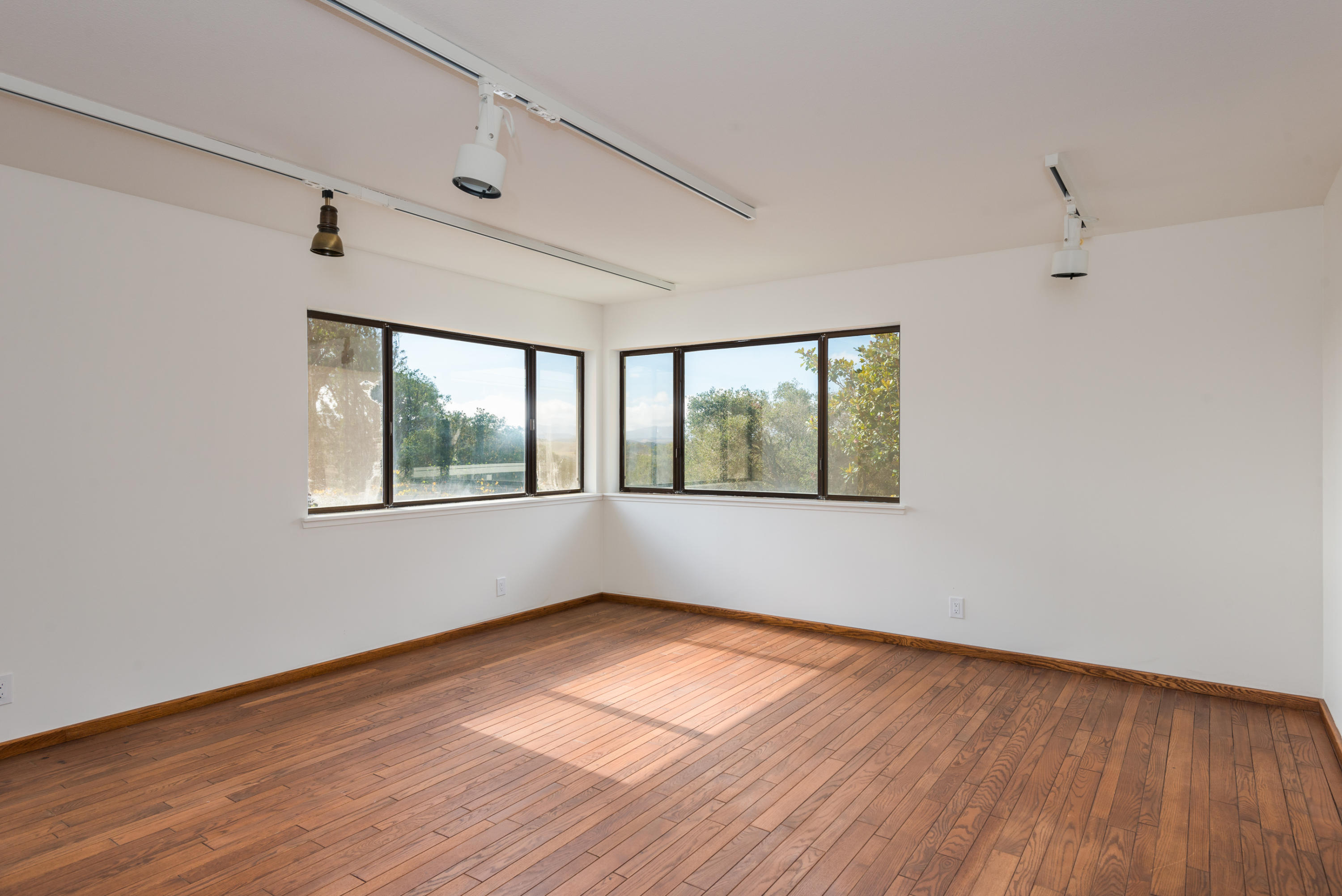 1815 Tularosa Road Lompoc, CA 93436 - Photo 28 of 35 an empty room with wooden floor and windows