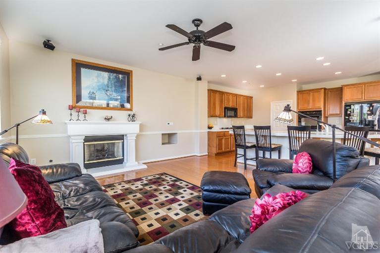 9898 Rhone Street Ventura, CA 93004 - Photo 11 of 44 a living room with furniture kitchen view and a fireplace