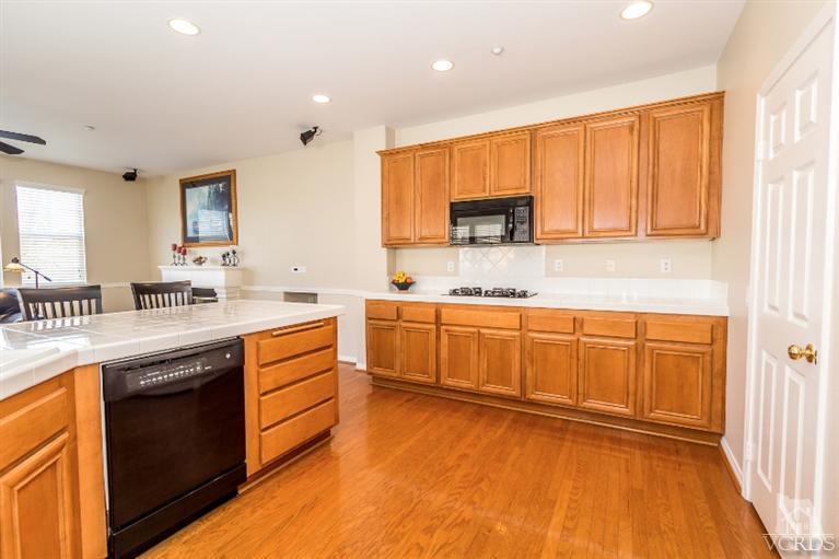 9898 Rhone Street Ventura, CA 93004 - Photo 14 of 44 a kitchen with stainless steel appliances granite countertop a stove a sink and a microwave