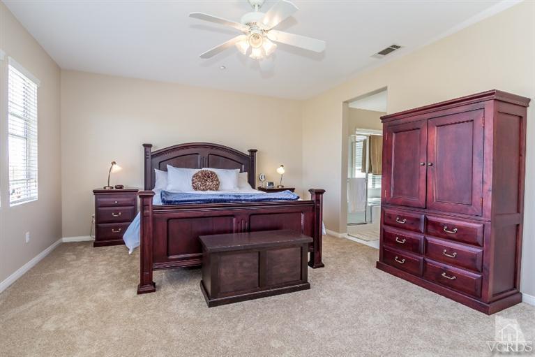 9898 Rhone Street Ventura, CA 93004 - Photo 22 of 44 a bedroom with a bed and a chandelier