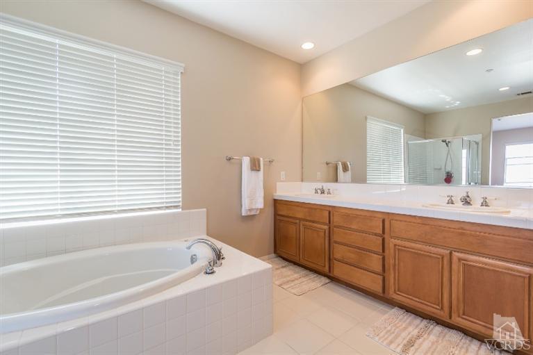 9898 Rhone Street Ventura, CA 93004 - Photo 25 of 44 a bathroom with a tub sink and mirror