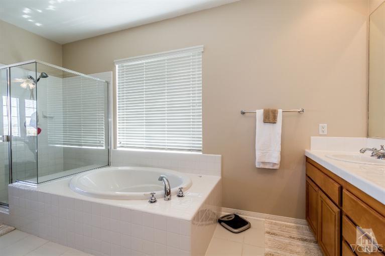9898 Rhone Street Ventura, CA 93004 - Photo 26 of 44 a bathroom with a tub sink and mirror