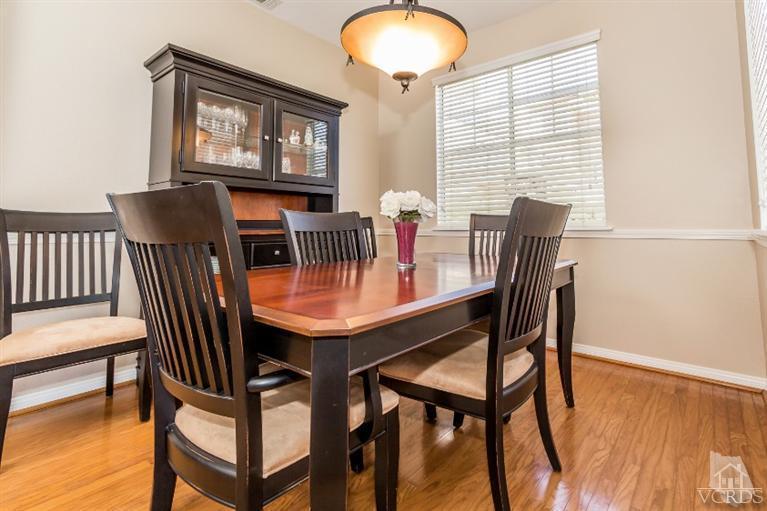 9898 Rhone Street Ventura, CA 93004 - Photo 8 of 44 a view of a dining room with furniture and wooden floor
