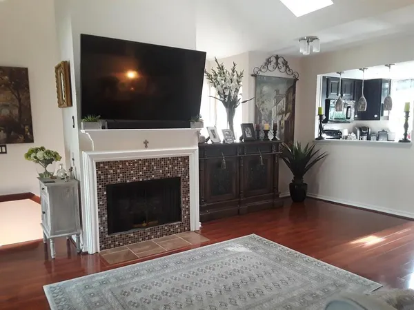 a living room with furniture a flat screen tv and a fireplace