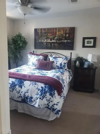 a bed sitting in a bedroom next to a window