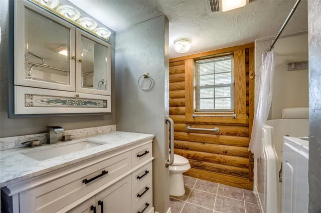 a bathroom with a sink a vanity and a mirror