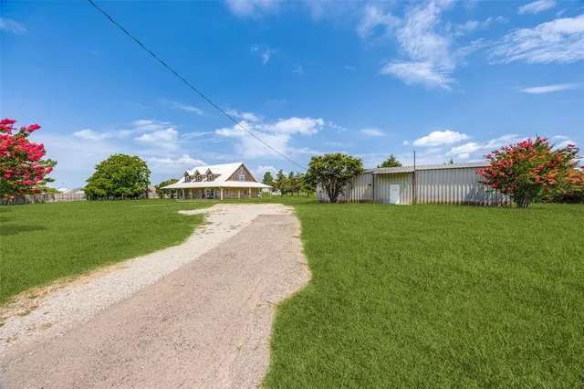 a view of a house with a yard and a garden
