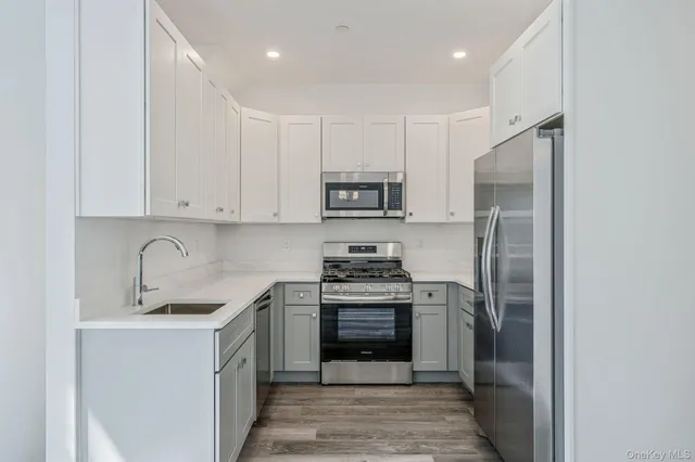 a kitchen with stainless steel appliances granite countertop a refrigerator sink and cabinets