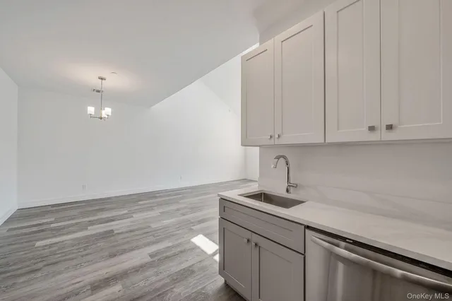 a view of a kitchen with microwave and cabinets