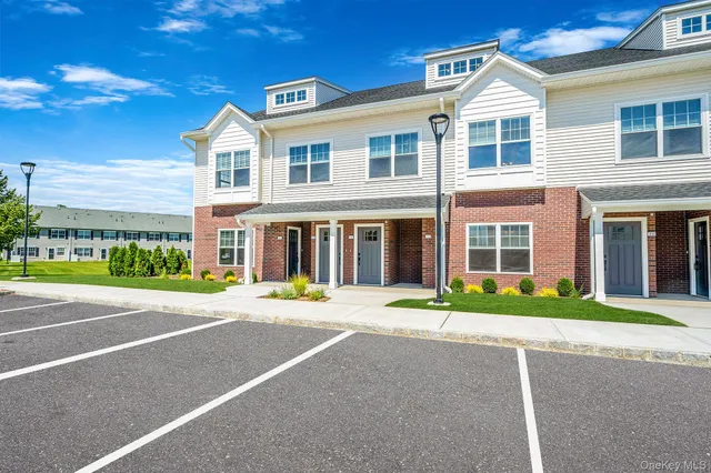 a front view of a building with a garden