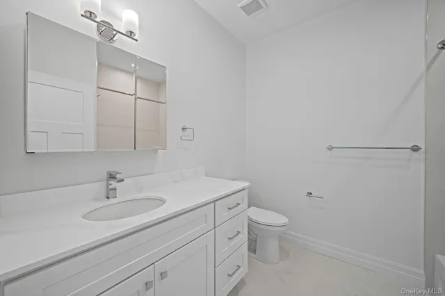 a bathroom with a sink toilet a vanity and mirror