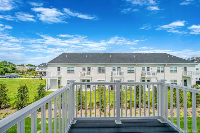 a view of a brick house with a big yard