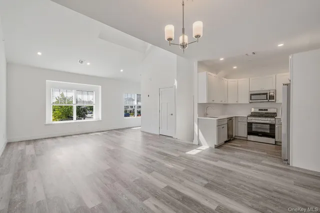 a view of kitchen with cabinets and wooden floor
