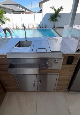 a view of barbeque grill with granite counter top