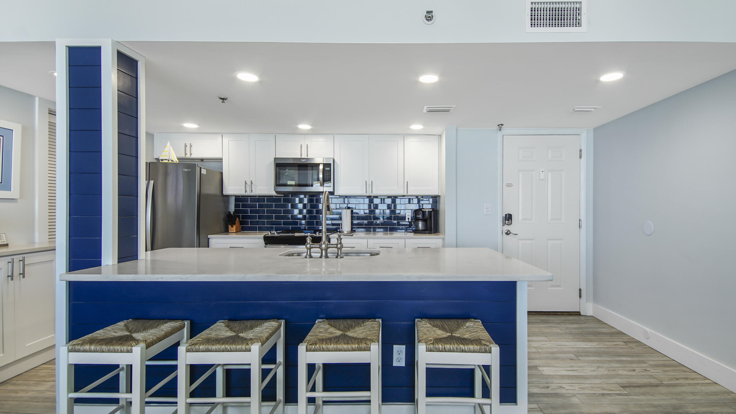 10509 Front Beach Road, Unit 100 Panama City Beach, FL 32408 - Photo 15 of 52 a view of kitchen with a dining table wooden floor and kitchen view