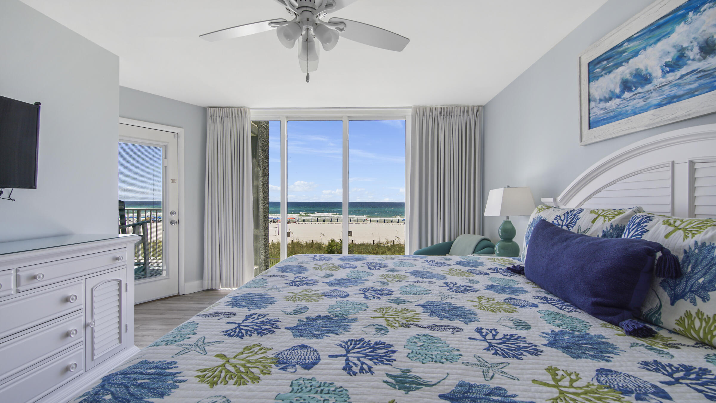 10509 Front Beach Road, Unit 100 Panama City Beach, FL 32408 - Photo 29 of 52 a bedroom with a large bed and a window
