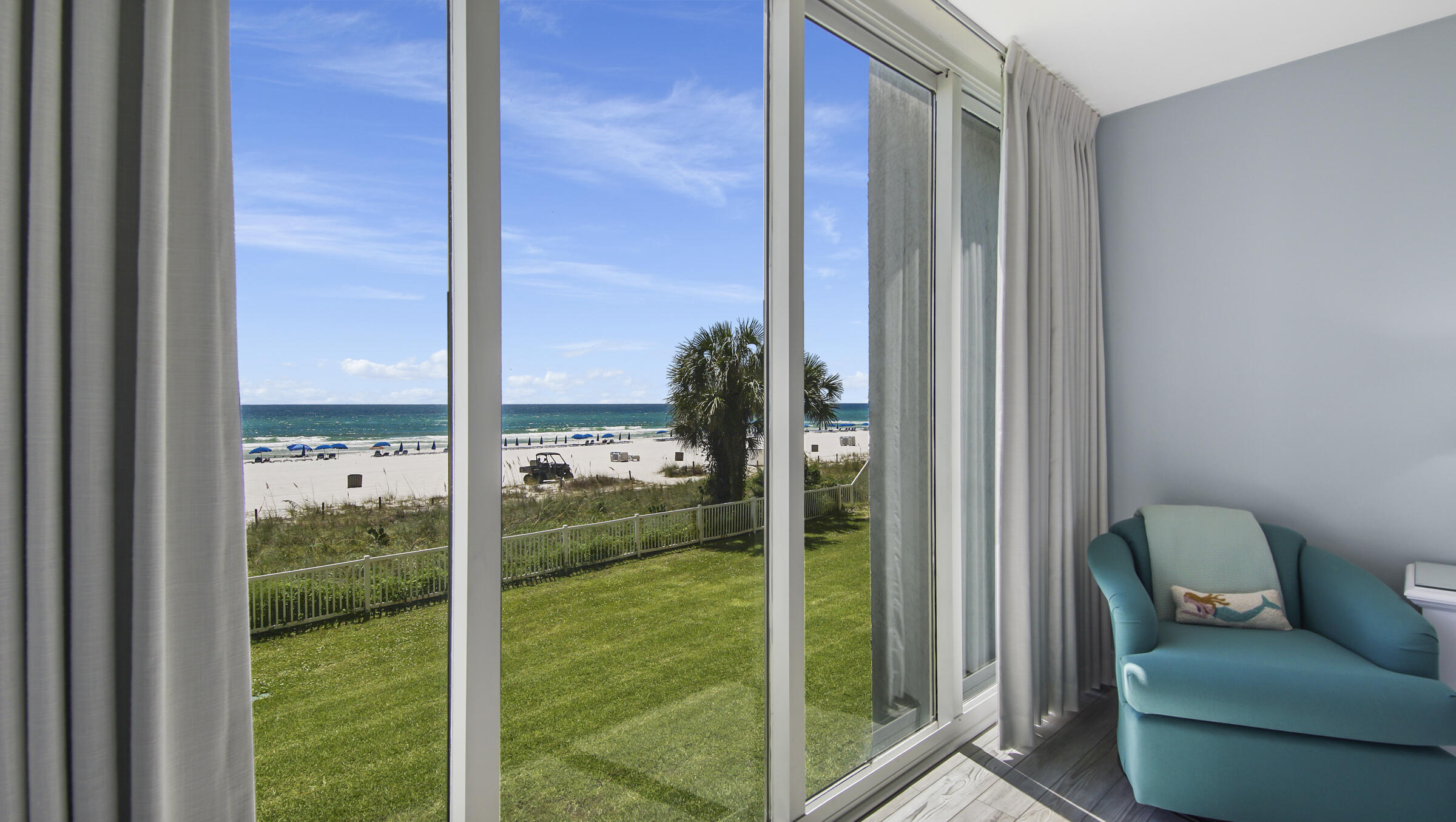 10509 Front Beach Road, Unit 100 Panama City Beach, FL 32408 - Photo 30 of 52 a room with yard view and a floor to ceiling window