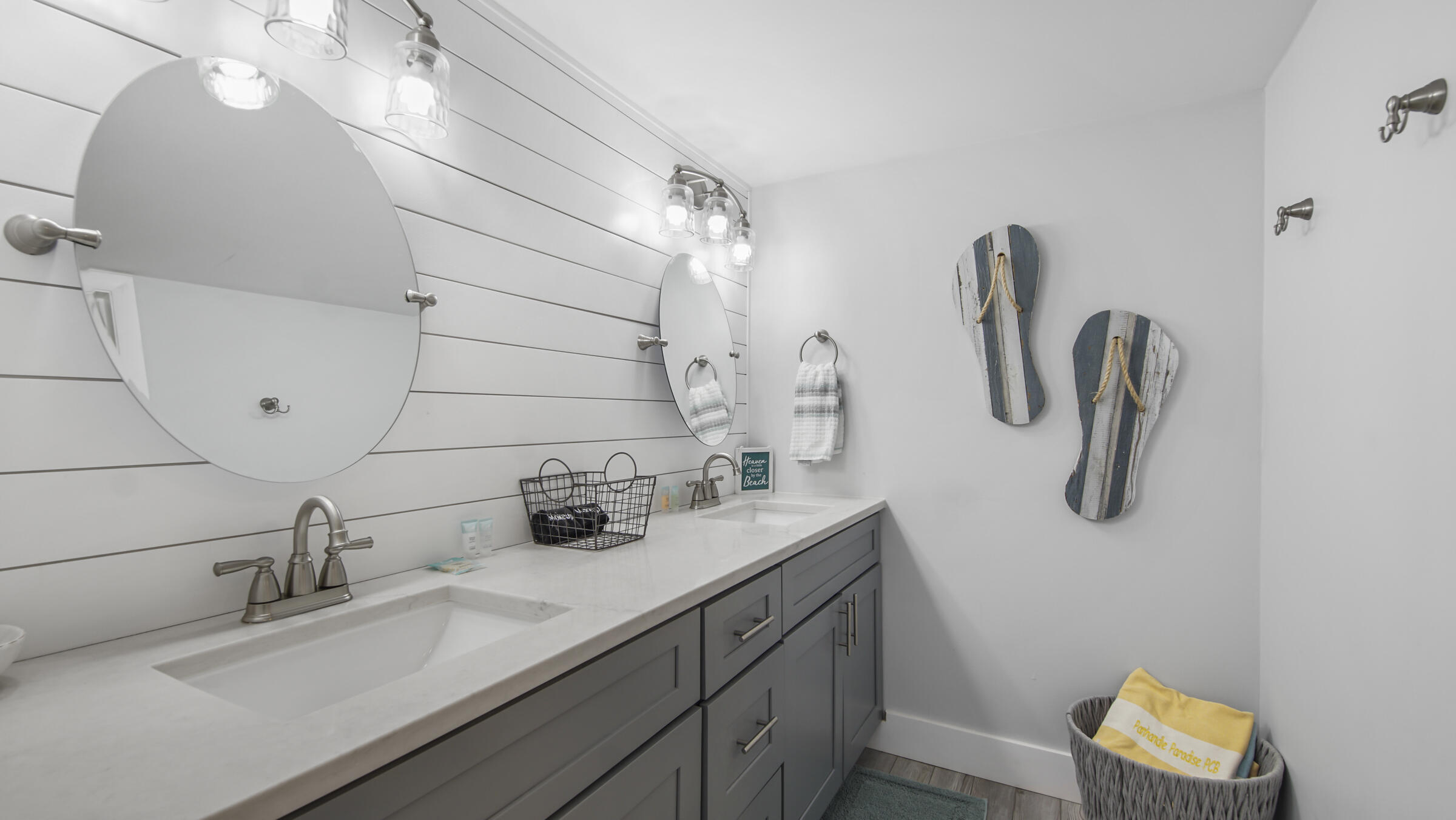 10509 Front Beach Road, Unit 100 Panama City Beach, FL 32408 - Photo 34 of 52 a bathroom with a sink and a mirror
