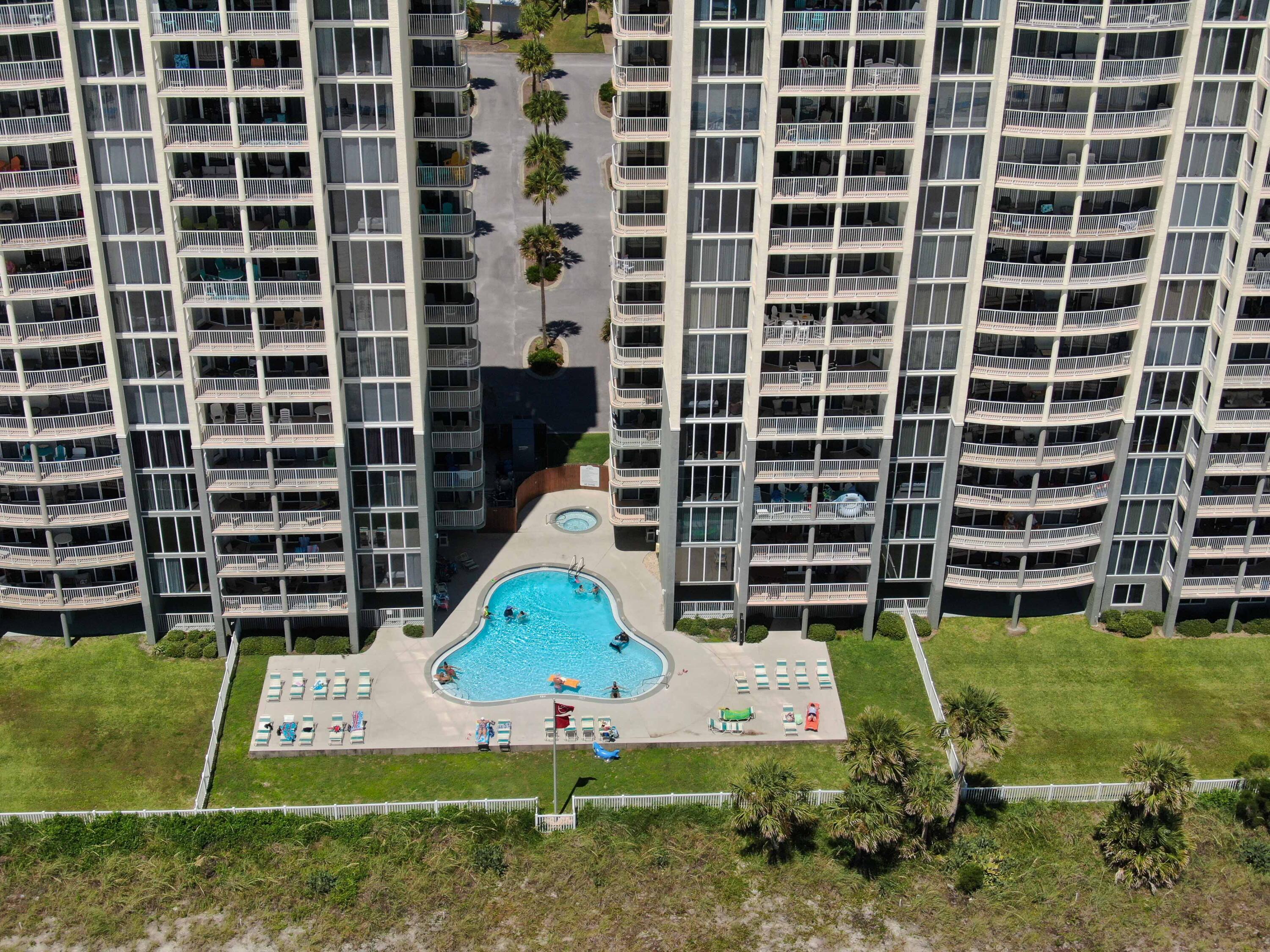 10509 Front Beach Road, Unit 100 Panama City Beach, FL 32408 - Photo 49 of 52 a front view of a building with garden