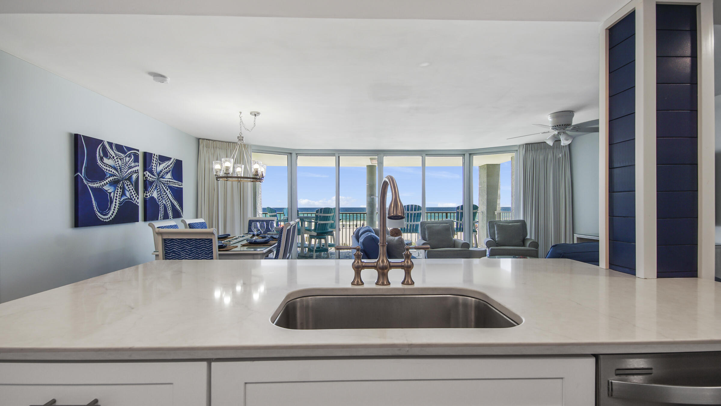 10509 Front Beach Road, Unit 100 Panama City Beach, FL 32408 - Photo 6 of 52 a view of kitchen sink and living room