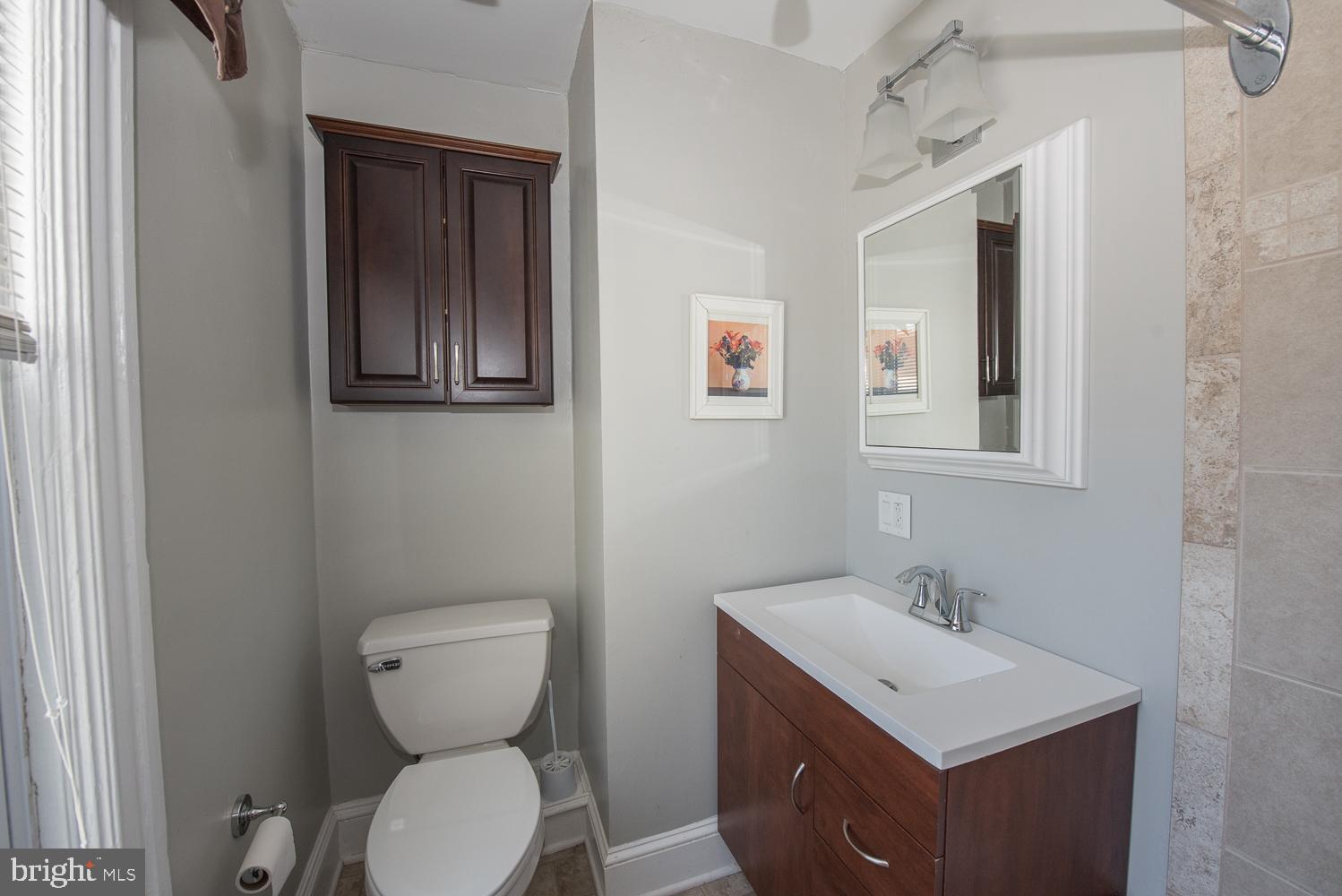 420 Darby Road Havertown, PA 19083 - Photo 12 of 21 a bathroom with a toilet sink and mirror