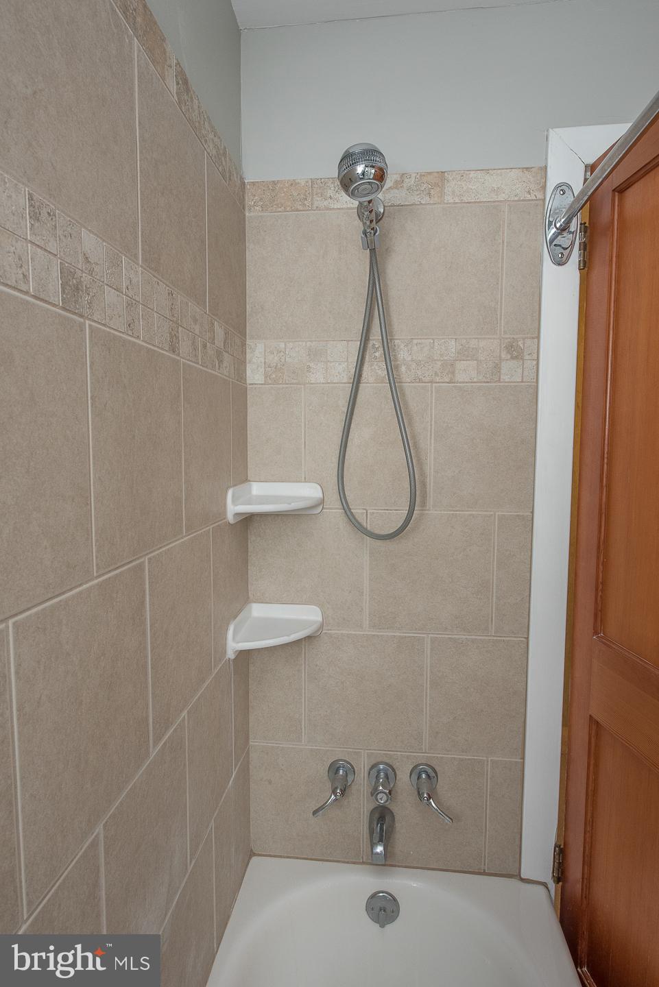 420 Darby Road Havertown, PA 19083 - Photo 13 of 21 a bathroom with a bath tub with a shower