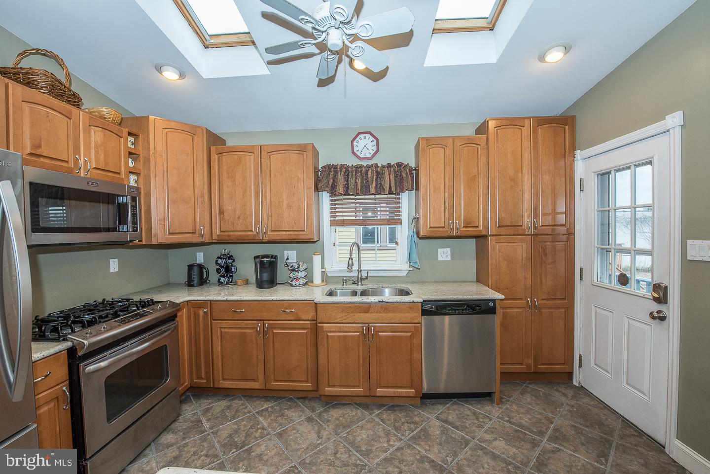 420 Darby Road Havertown, PA 19083 - Photo 6 of 21 a kitchen with stainless steel appliances granite countertop a stove a sink dishwasher and a refrigerator