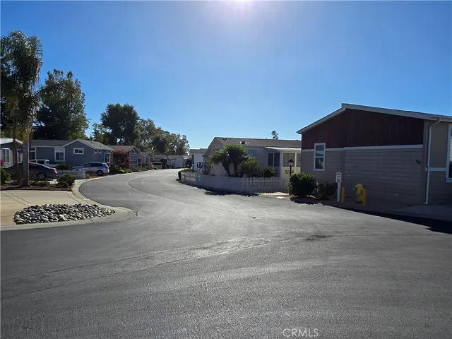 a black white building with a yard and parking space