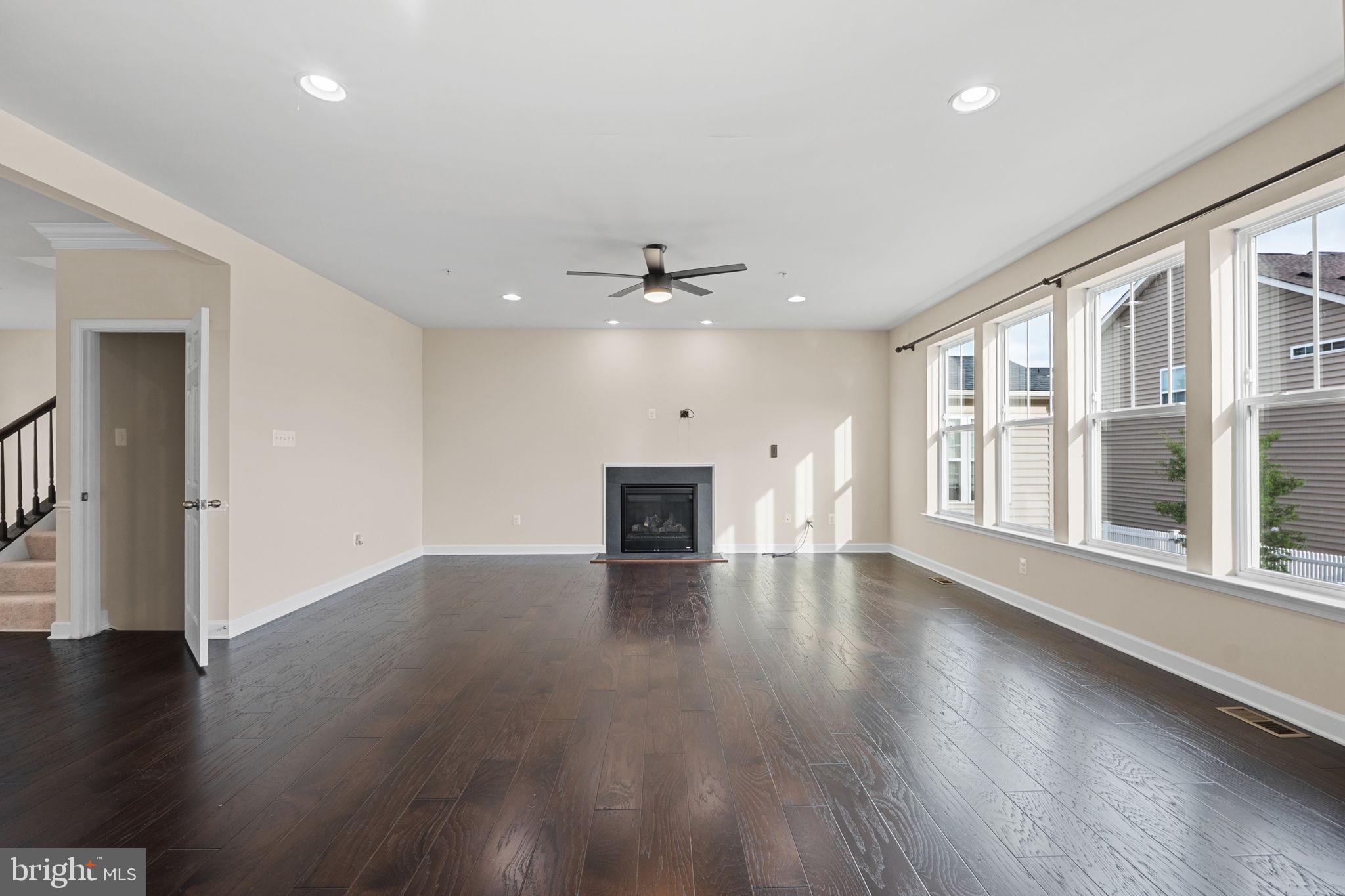 803 Holden Road Frederick, MD 21701 - Photo 19 of 63 a view of an empty room with wooden floor and a window