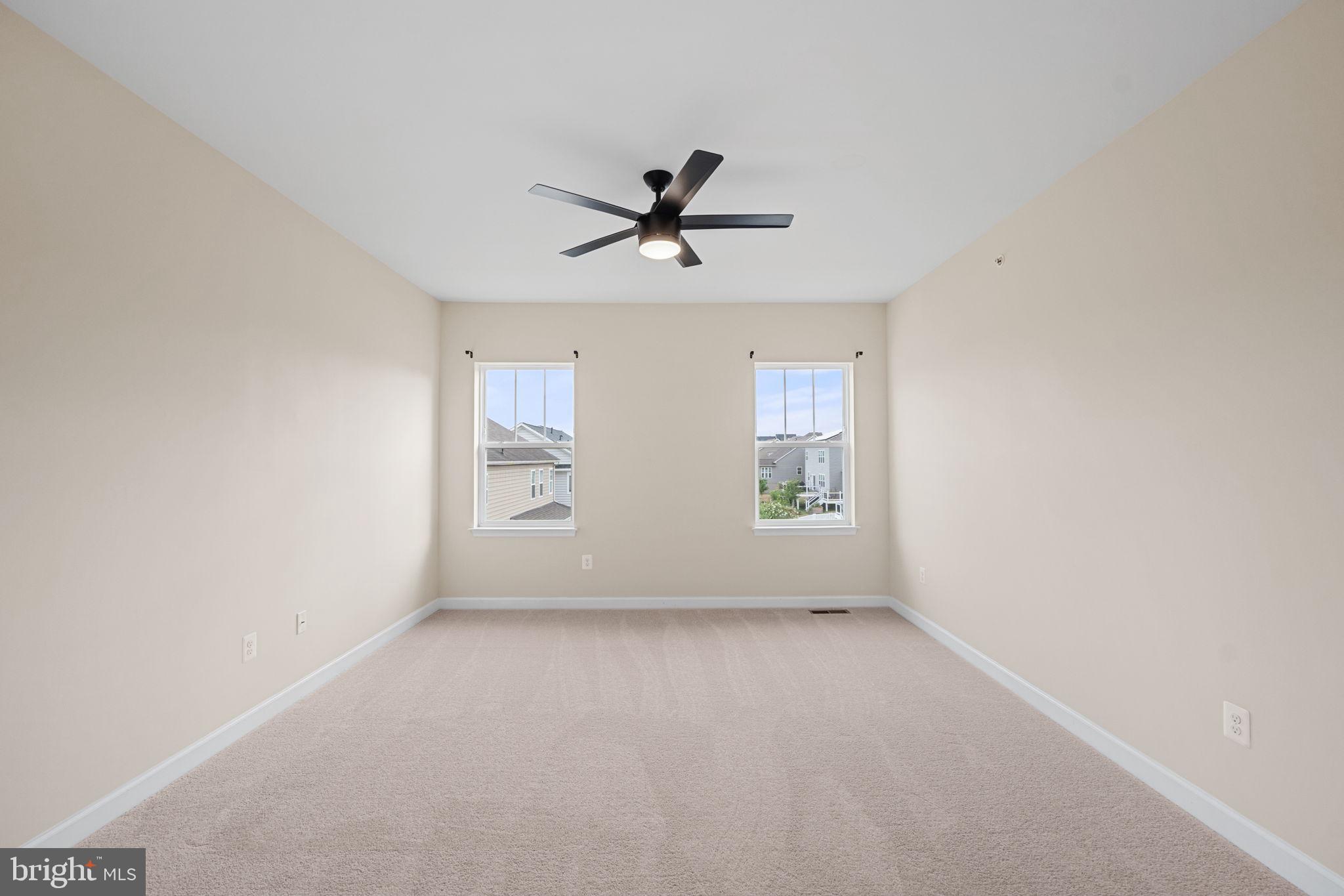 803 Holden Road Frederick, MD 21701 - Photo 24 of 63 an empty room with windows and ceiling fan view