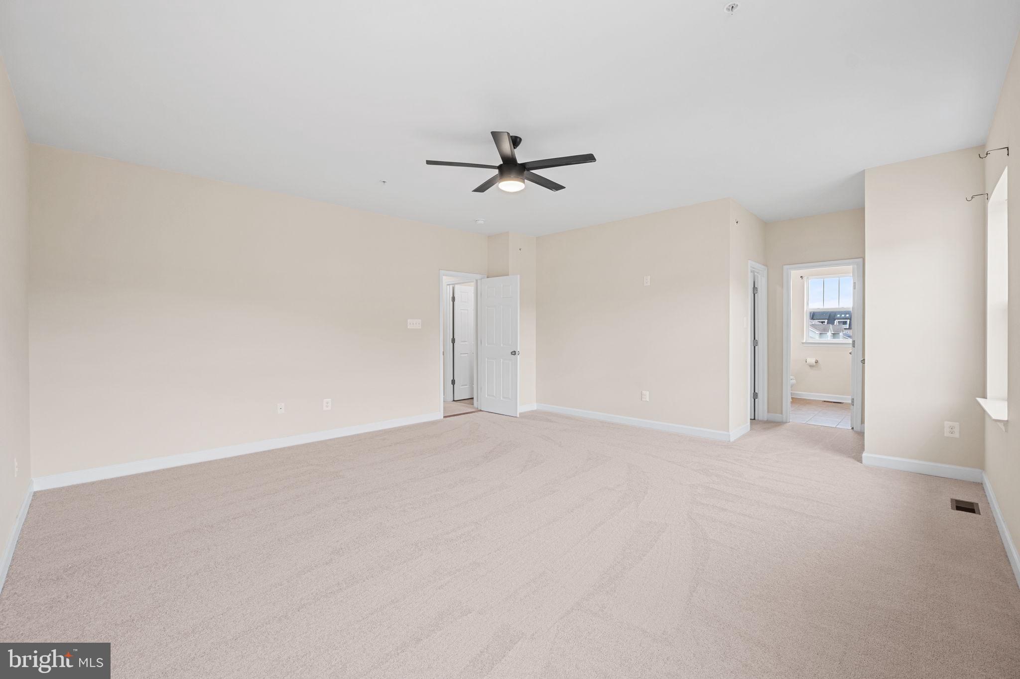 803 Holden Road Frederick, MD 21701 - Photo 29 of 63 an empty room with chandelier fan and windows