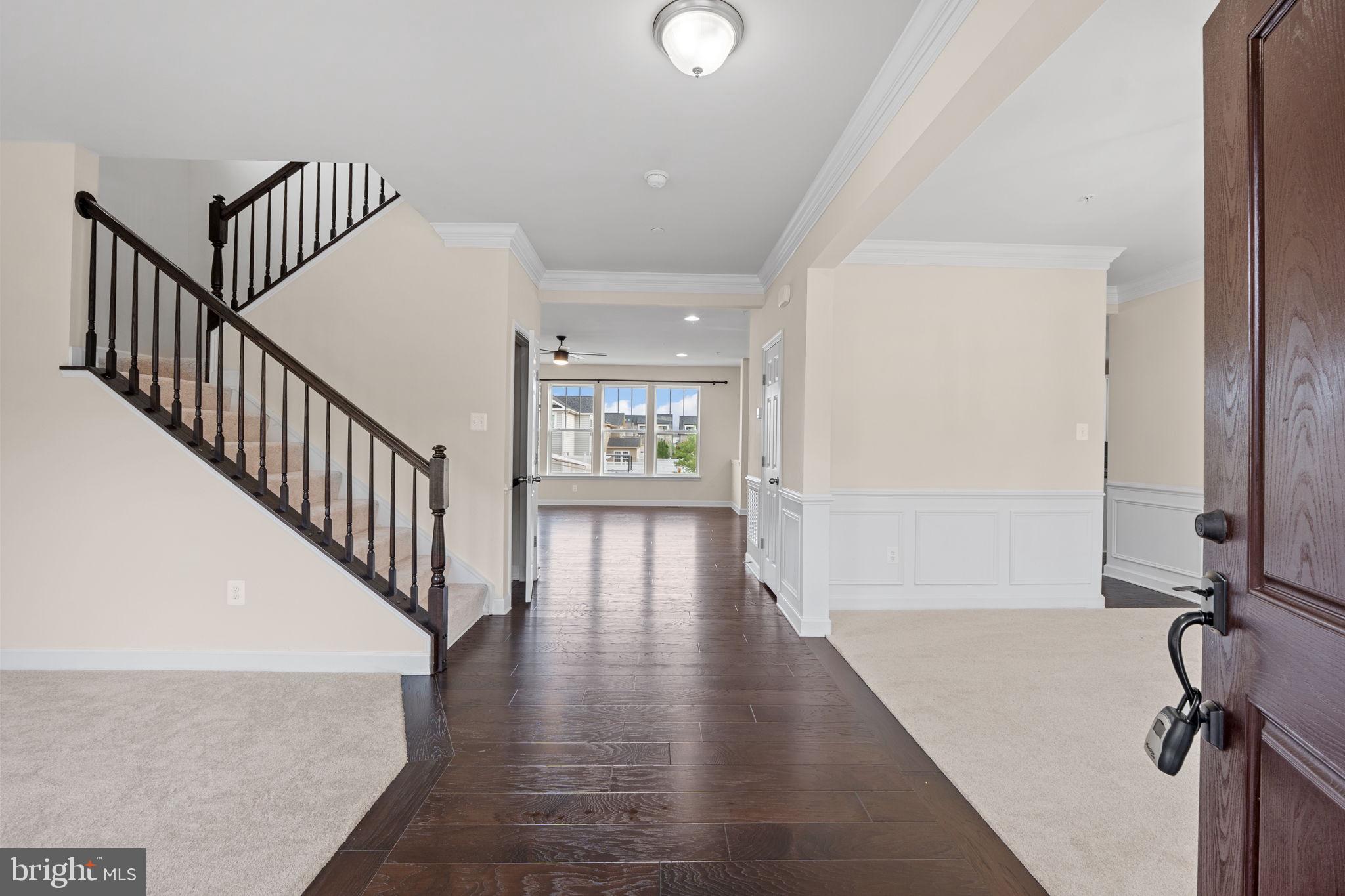 803 Holden Road Frederick, MD 21701 - Photo 3 of 63 a view of a hallway with wooden floor and stairs