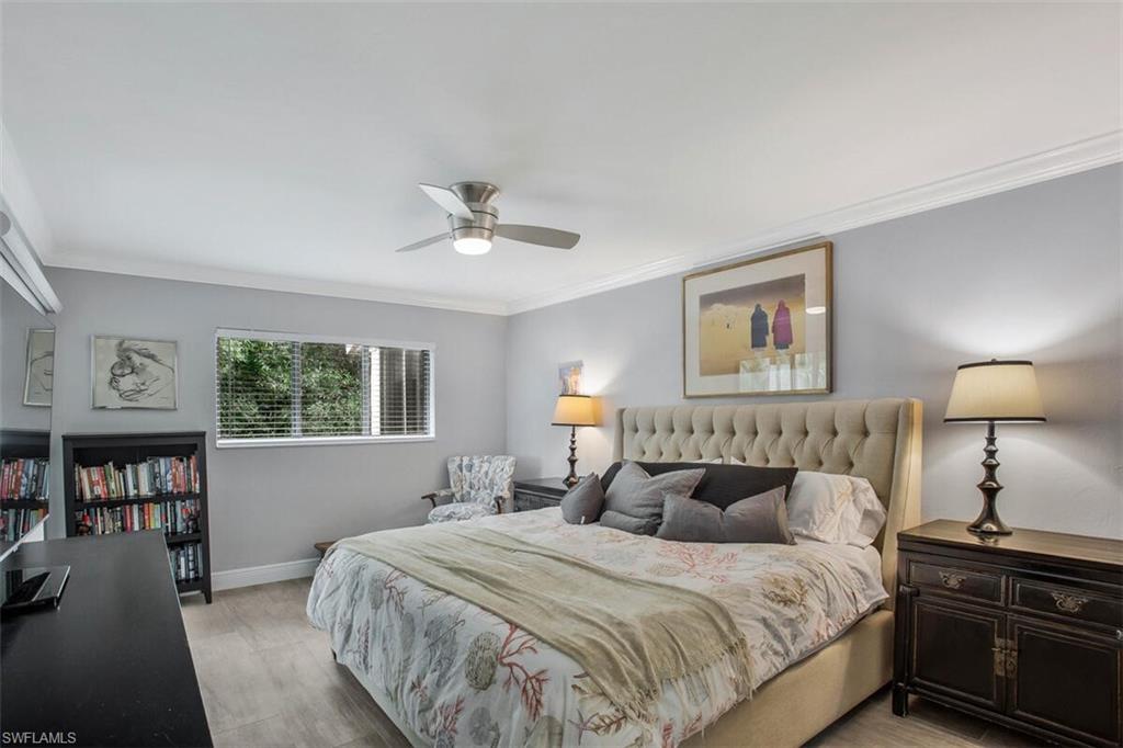 910 Vanderbilt Beach Road, Unit 123W Naples, FL 34108 - Photo 12 of 33 Bedroom with ceiling fan, light hardwood / wood-style flooring, and ornamental molding
