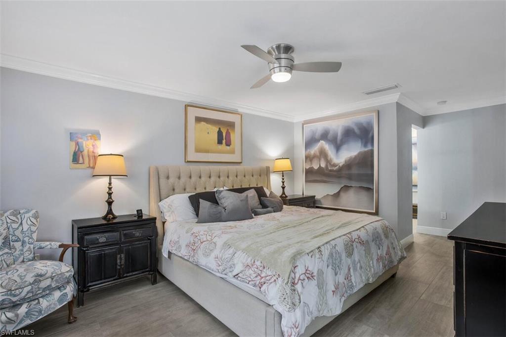 910 Vanderbilt Beach Road, Unit 123W Naples, FL 34108 - Photo 13 of 33 Bedroom with ornamental molding, hardwood / wood-style floors, and ceiling fan
