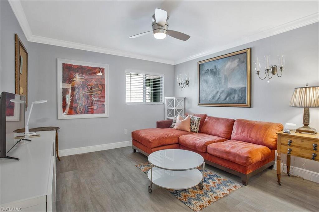 910 Vanderbilt Beach Road, Unit 123W Naples, FL 34108 - Photo 20 of 33 Living room with light hardwood / wood-style flooring, ceiling fan, and crown molding