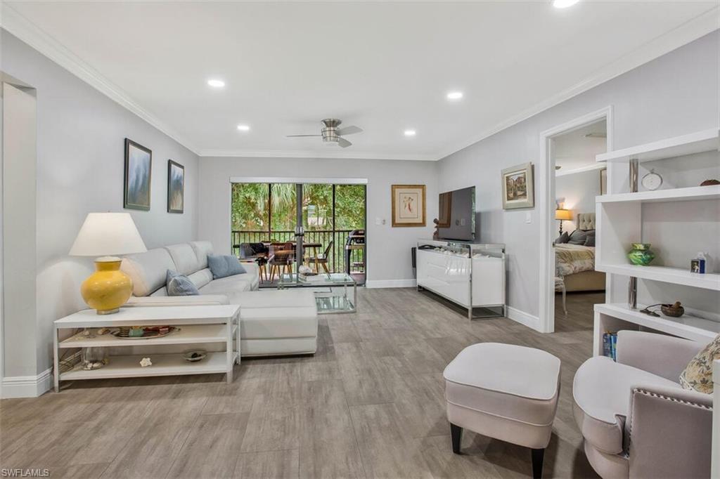 910 Vanderbilt Beach Road, Unit 123W Naples, FL 34108 - Photo 5 of 33 Living room featuring ornamental molding, light hardwood / wood-style floors, and ceiling fan