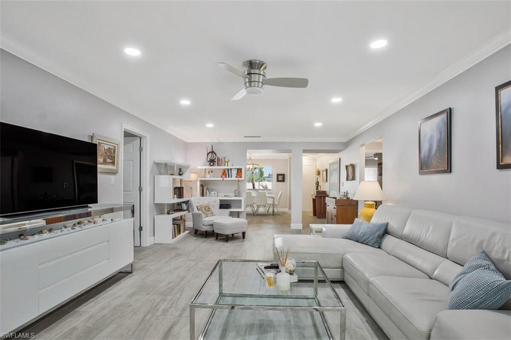 910 Vanderbilt Beach Road, Unit 123W Naples, FL 34108 - Photo 6 of 33 Living room featuring ceiling fan, light wood-type flooring, and crown molding