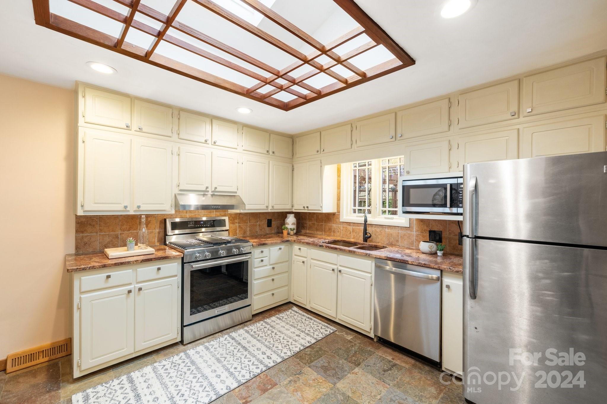 2 Devonshire Place Asheville, NC 28803 - Photo 15 of 47 a kitchen with a sink stainless steel appliances and cabinets