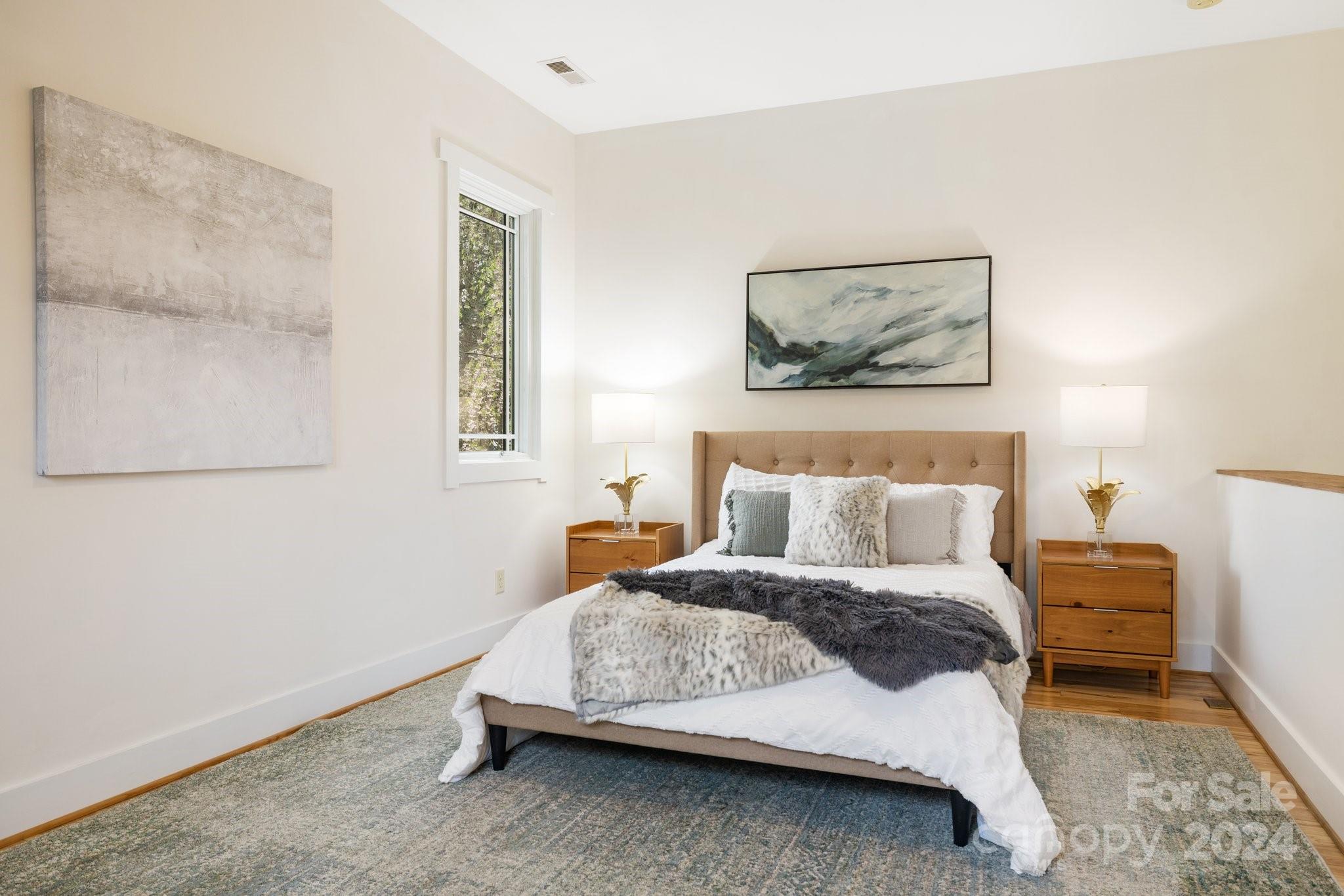 2 Devonshire Place Asheville, NC 28803 - Photo 22 of 47 a bedroom with a bed and a painting on the wall