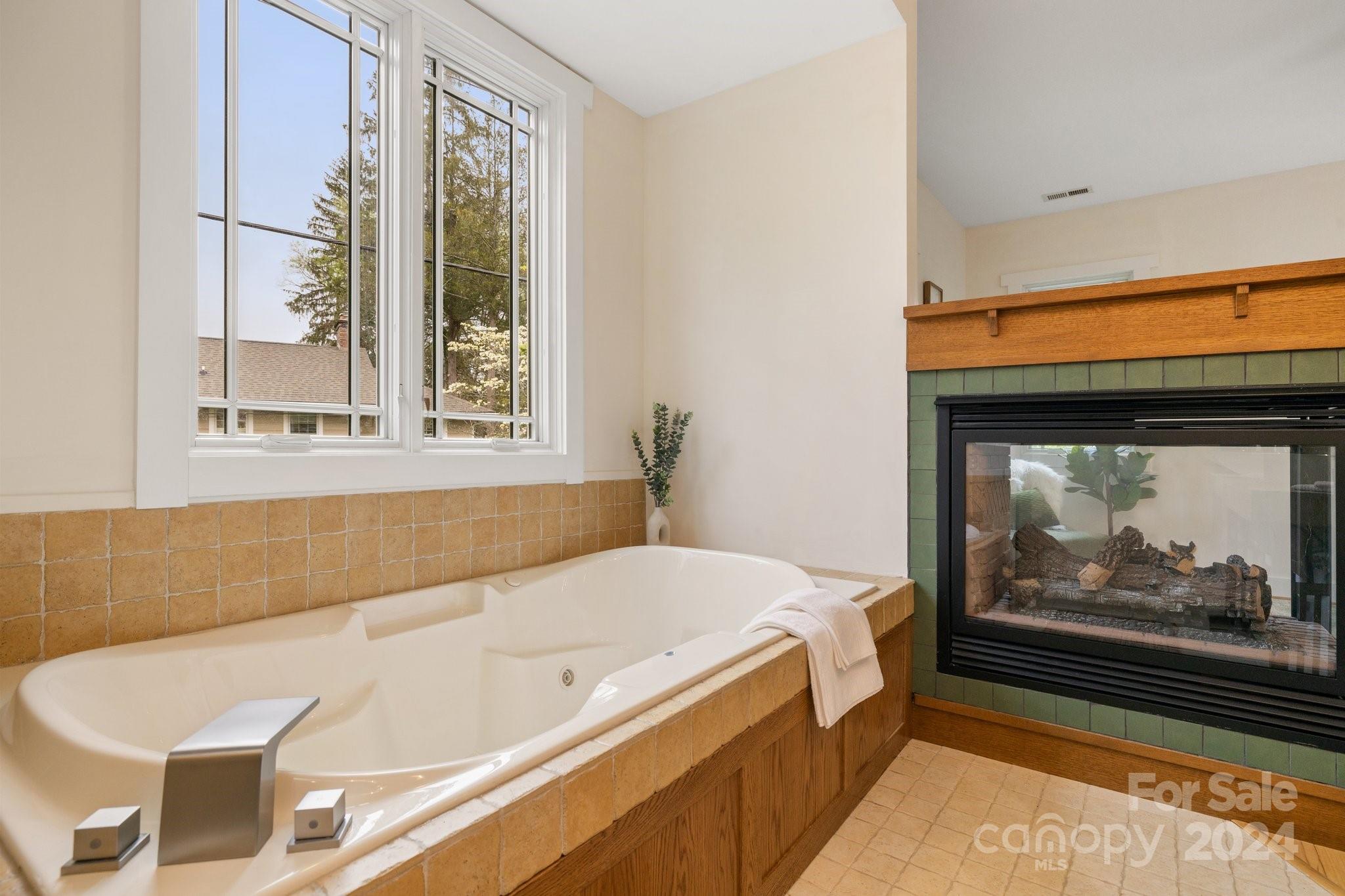 2 Devonshire Place Asheville, NC 28803 - Photo 24 of 47 a bathroom with a bathtub and window