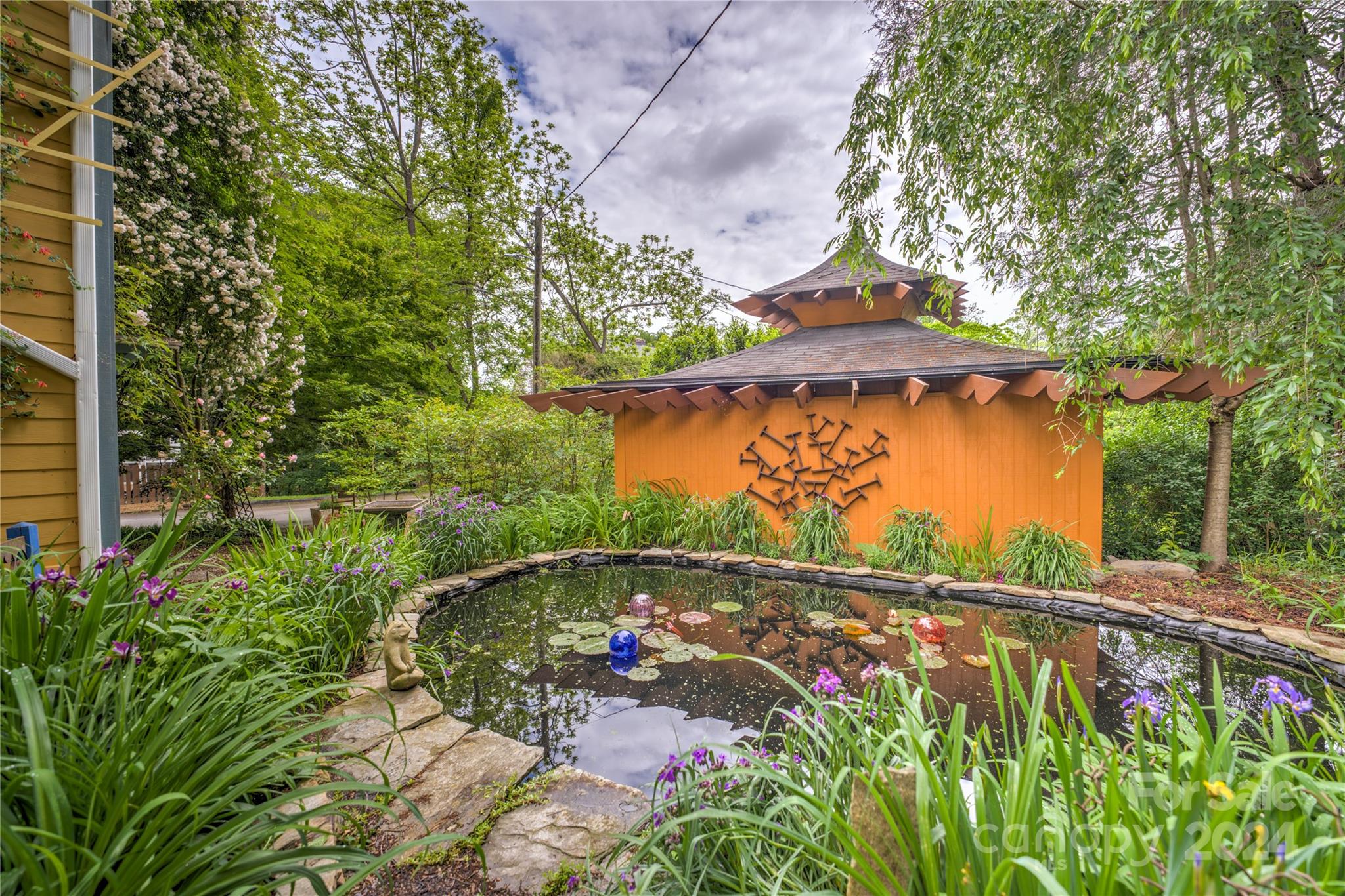2 Devonshire Place Asheville, NC 28803 - Photo 40 of 47 a view of a garden with a bench under an umbrella