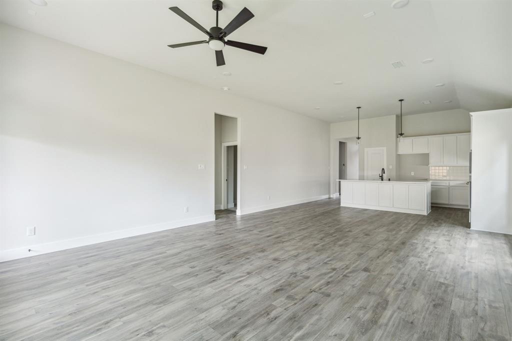 6145 Tahoe Winds Drive Pilot Point, TX 76258 - Photo 12 of 28 a view of a livingroom with a hardwood floor and a ceiling fan