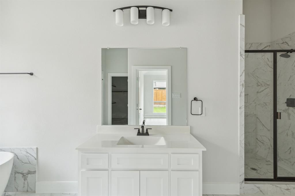 6145 Tahoe Winds Drive Pilot Point, TX 76258 - Photo 16 of 28 a bathroom with a sink and a mirror