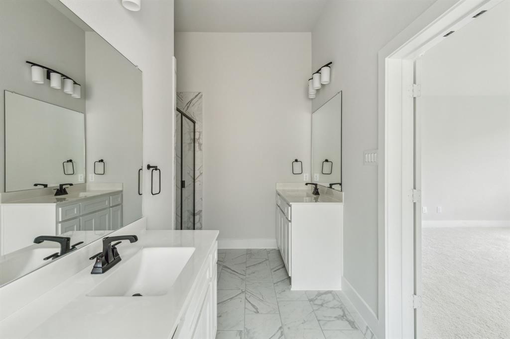 6145 Tahoe Winds Drive Pilot Point, TX 76258 - Photo 18 of 28 a bathroom with a tub sink and mirror