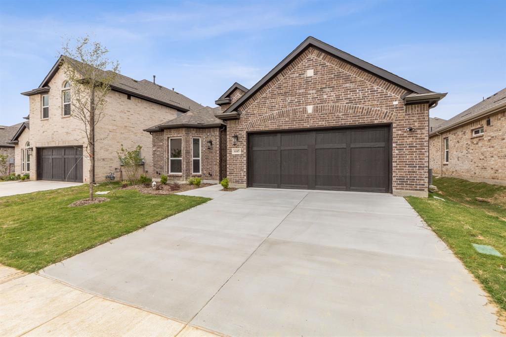 6145 Tahoe Winds Drive Pilot Point, TX 76258 - Photo 2 of 28 a front view of a house with a yard and garage