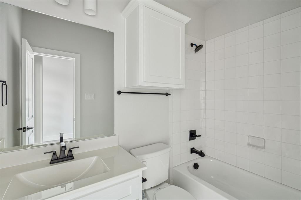 6145 Tahoe Winds Drive Pilot Point, TX 76258 - Photo 21 of 28 a bathroom with a sink a toilet and shower